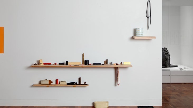 A photo of an art museum interior depicting shelves lines with artworks