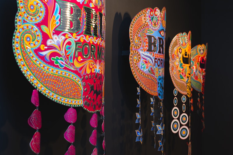 Abdullah M.I. Syed, Brut for Men series (2013), hand-beaten metal medallion and chamak patti (hand-made sticker ornamentation), wood, stainless steel; installation view, 4A Centre for Contemporary Asian Art. Courtesy the artist. Image: Document Photography.