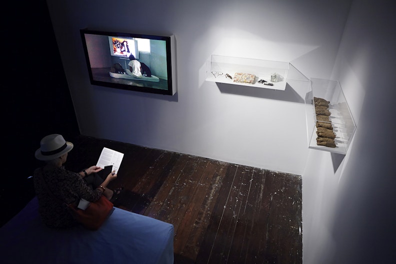 Araya Rasdjarmrearnsook, Treachery of the Moon (2012), single- channel video, eye glasses, mobile phone, dog splints; installation view, 4A Centre for Contemporary Asian Art. Courtesy Araya Rasdjarmrearnsook. Photo: Zan Wimberley