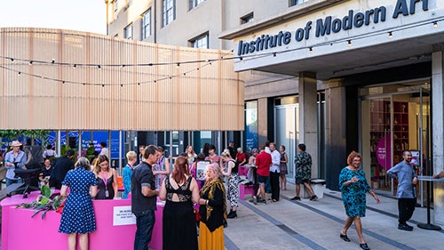 The exterior of the Institute of Modern Art in Brisbane, with a crowd gathered out the front.
