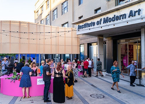 The exterior of the Institute of Modern Art in Brisbane, with a crowd gathered out the front.