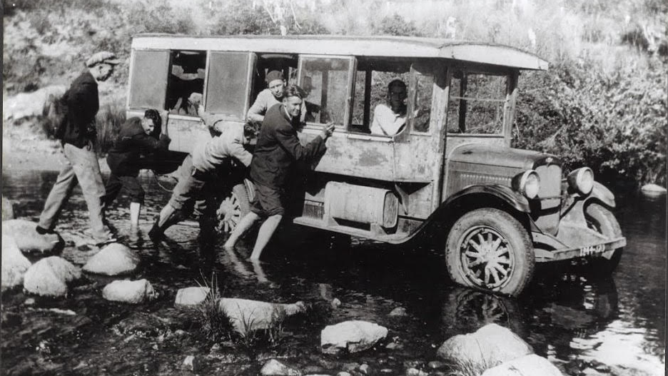 Brothers Barney and Ted Dion in 1920s Chevrolet wooden-bodied bus receive help crossing the Cann River December 1932 .