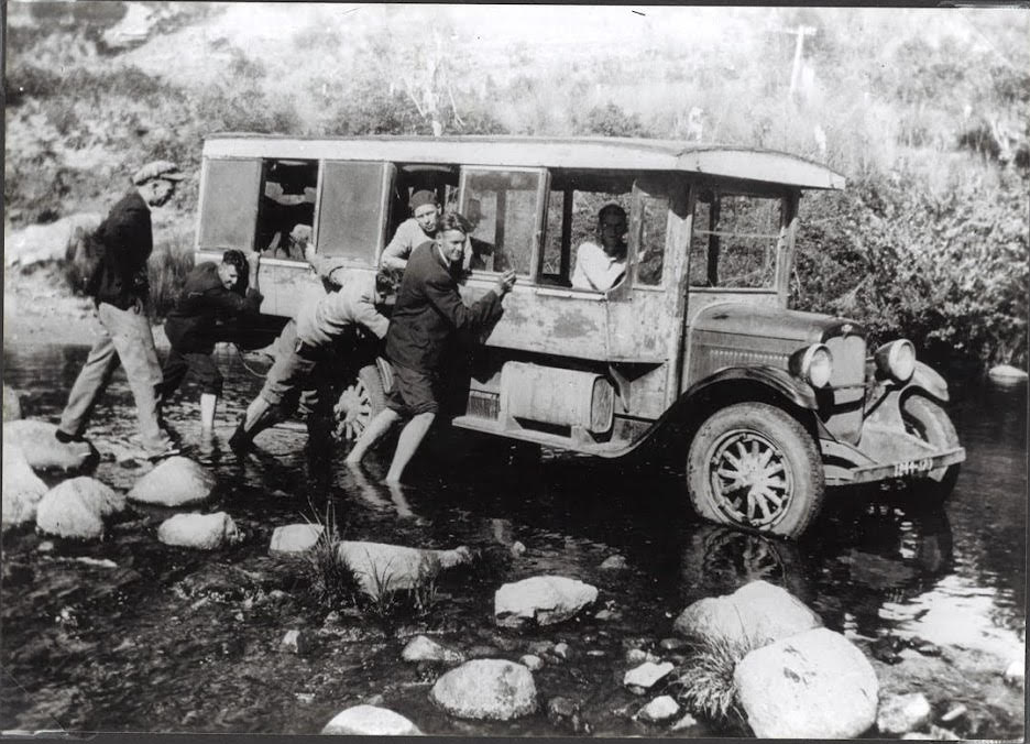 Brothers Barney and Ted Dion in 1920s Chevrolet wooden-bodied bus receive help crossing the Cann River December 1932 .