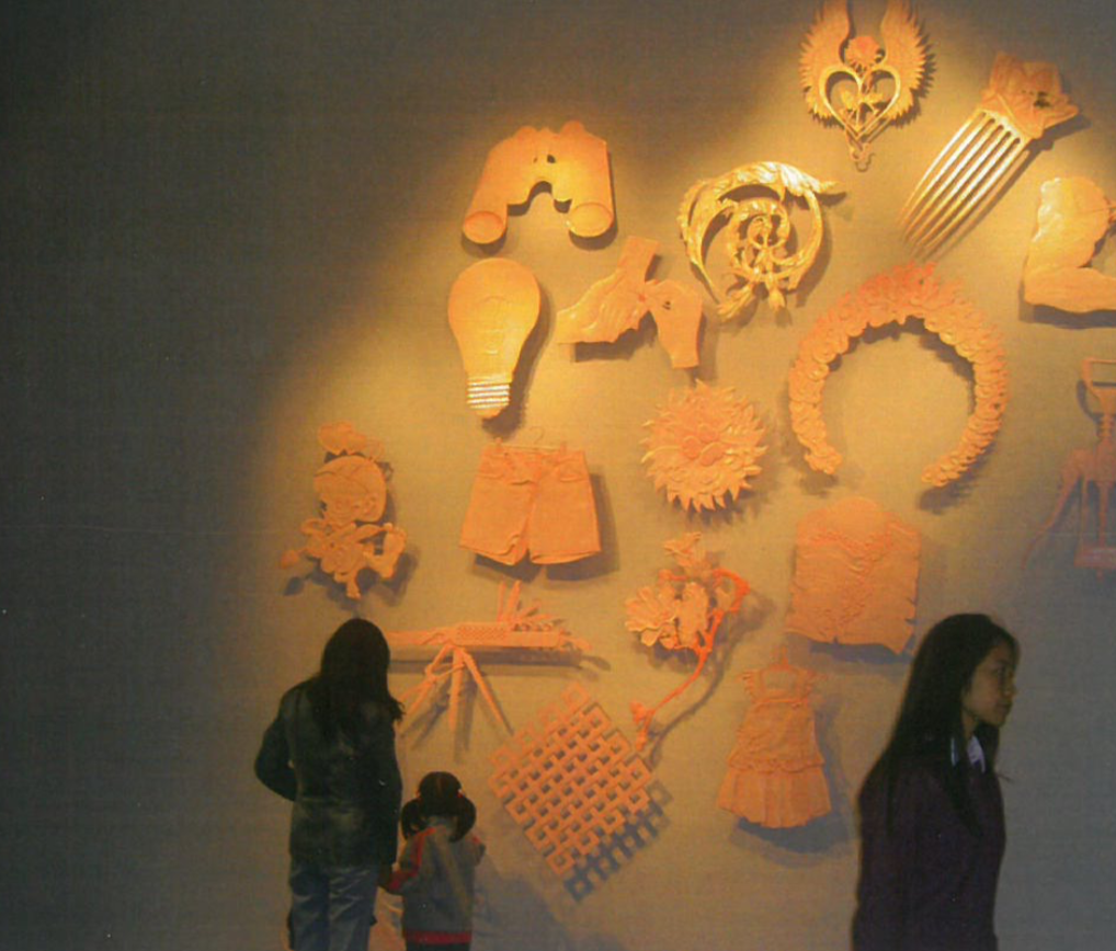 Gallery visitors at the "Asian Traffic" Shanghai exhibition, observing artworks on a wall.