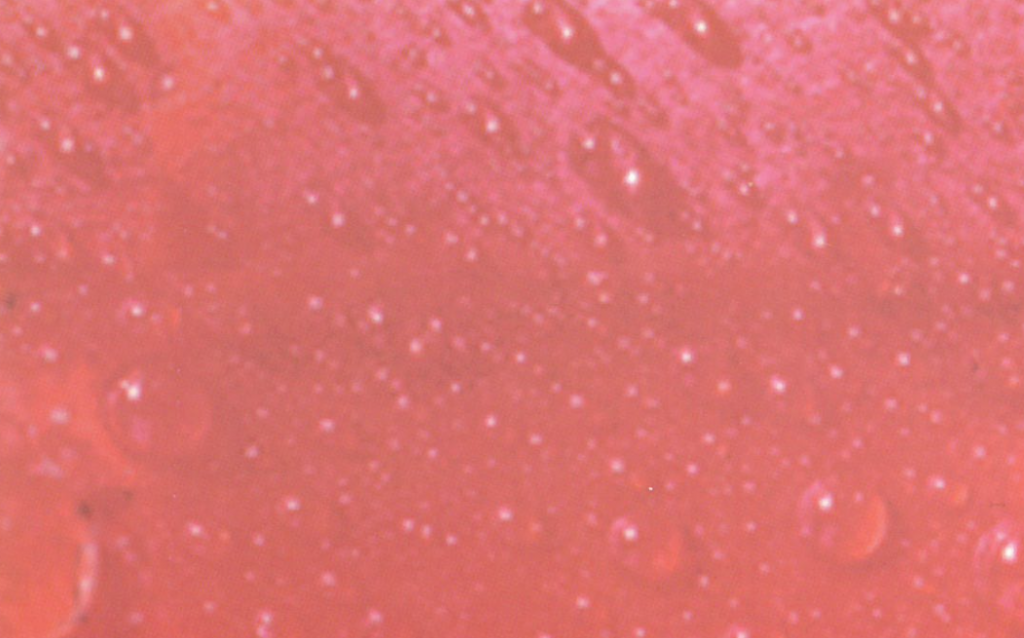 Water droplets on a pink background.