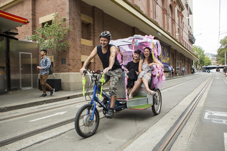Louise Zhang and 4A Gallery Director Mikala Tai ride a rickshaw Louise decorated to celebrate Chinese New Year (photo by Jamie Williams/City of Sydney)