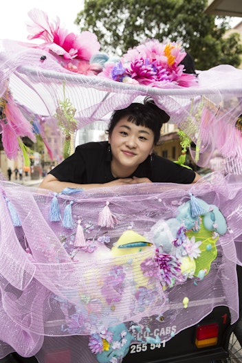 Louise Zhang with a rickshaw she decorated to celebrate Chinese New Year  (photo by Jamie Williams/City of Sydney)