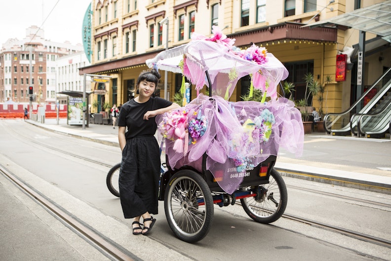 Louise Zhang with a rickshaw she decorated to celebrate Chinese New Year  (photo by Jamie Williams/City of Sydney)