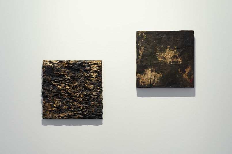 Kirtika Kain, larva, 2022, cotton, tar, gold leaf on recycled silkscreen, 37 x 37cm; Kirtika Kain, The Solar Line IX, 2020, tar, gold leaf, rice paper, silicon carbide, beeswax, disused silk screen, 35 x 35cm. Courtesy the artist and Roslyn Oxley9 Gallery, Sydney.