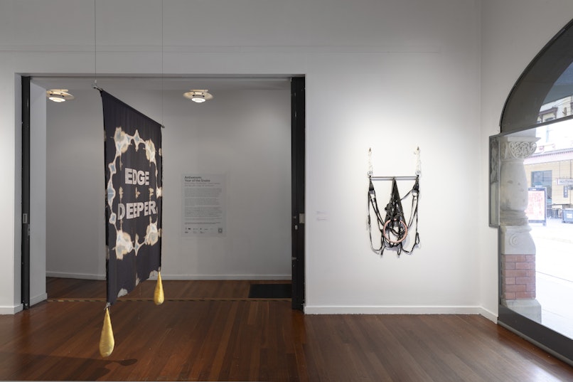 Owen Leong, Bud, 2023, bronze finger hooks, rope, stainless steel, spreader bar, leather cuffs, hand cut denim, glazed porcelain, 135 x 70 x 7cm. Courtesy the artist.