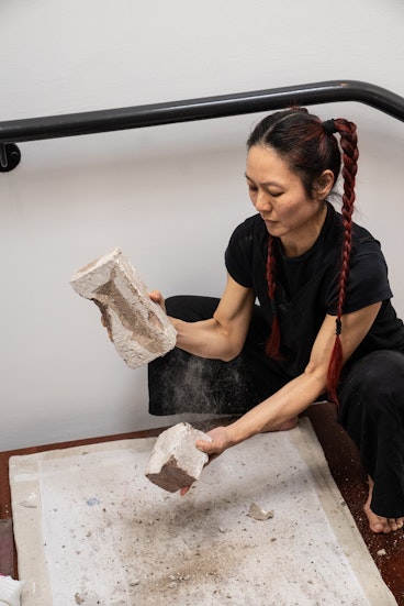 Weizen Ho, material : brick ~ material : body (performance view), 2026. Photograph by Christina Mishell.