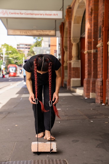 Weizen Ho, material : brick ~ material : body (performance view), 2026. Photograph by Christina Mishell.