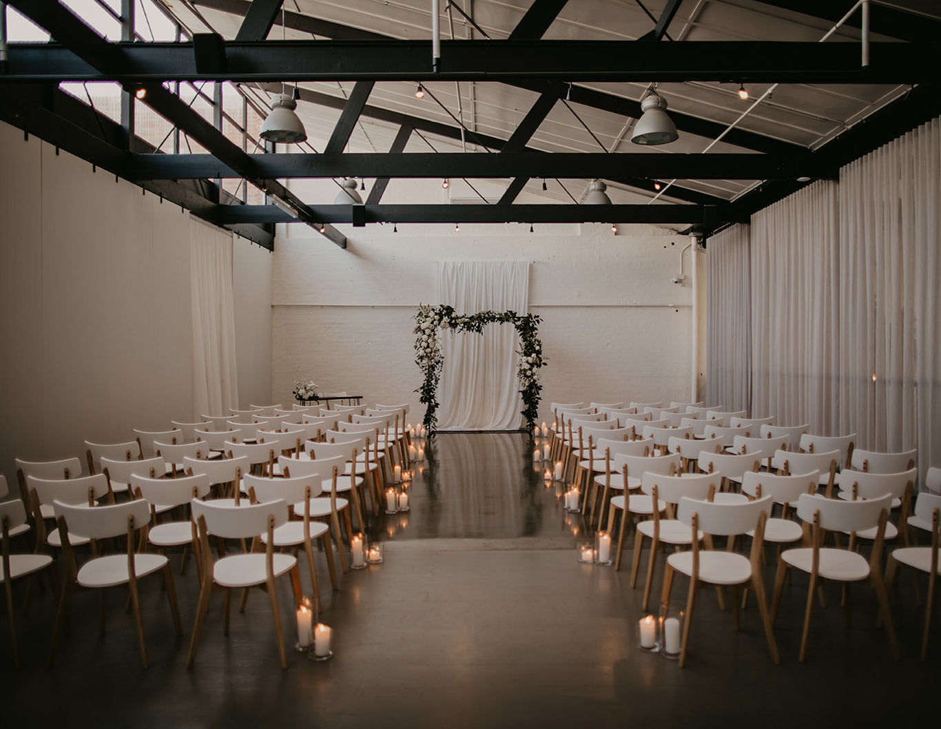 Candlelit wedding ceremony looking down the aisle.