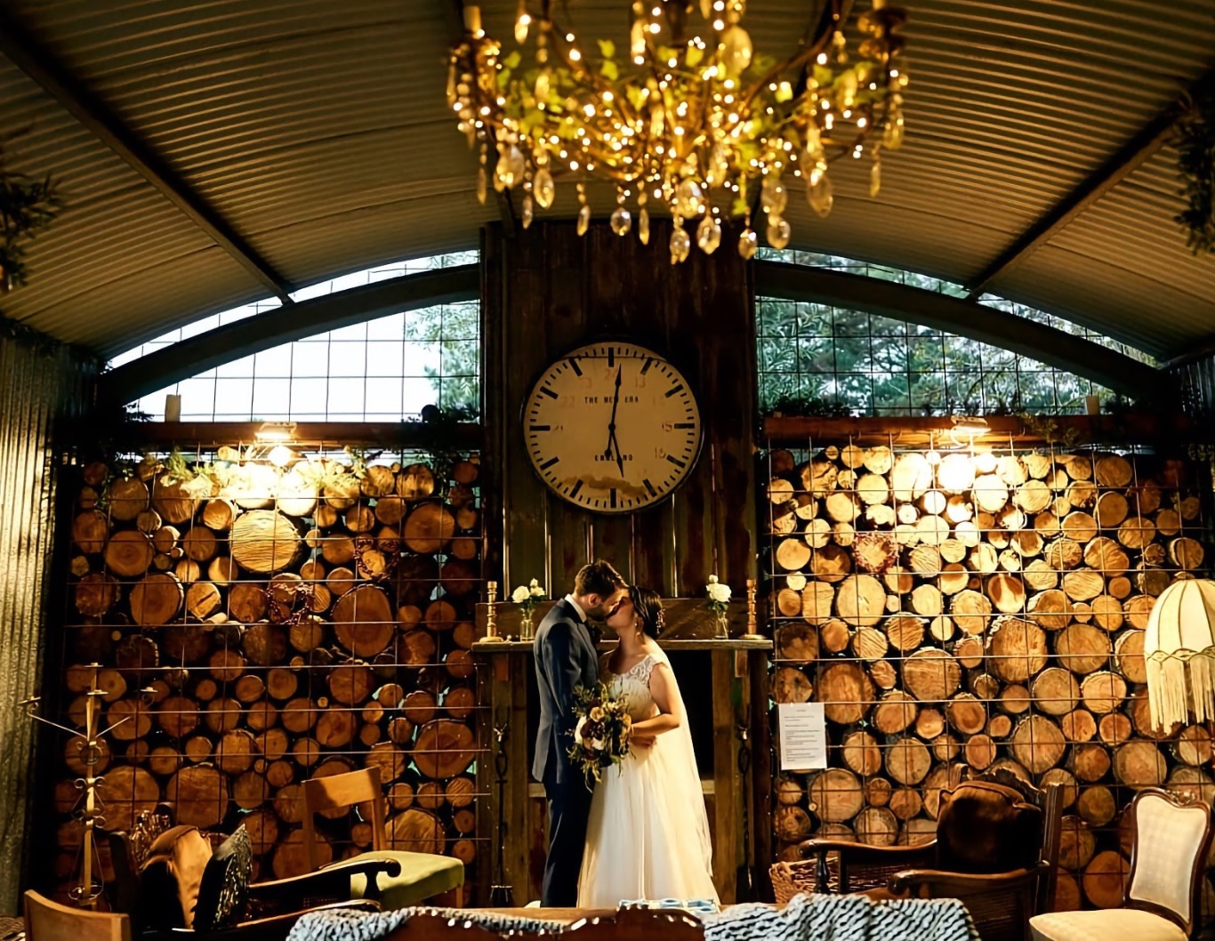 Wedding couple embrace in a country cabin.