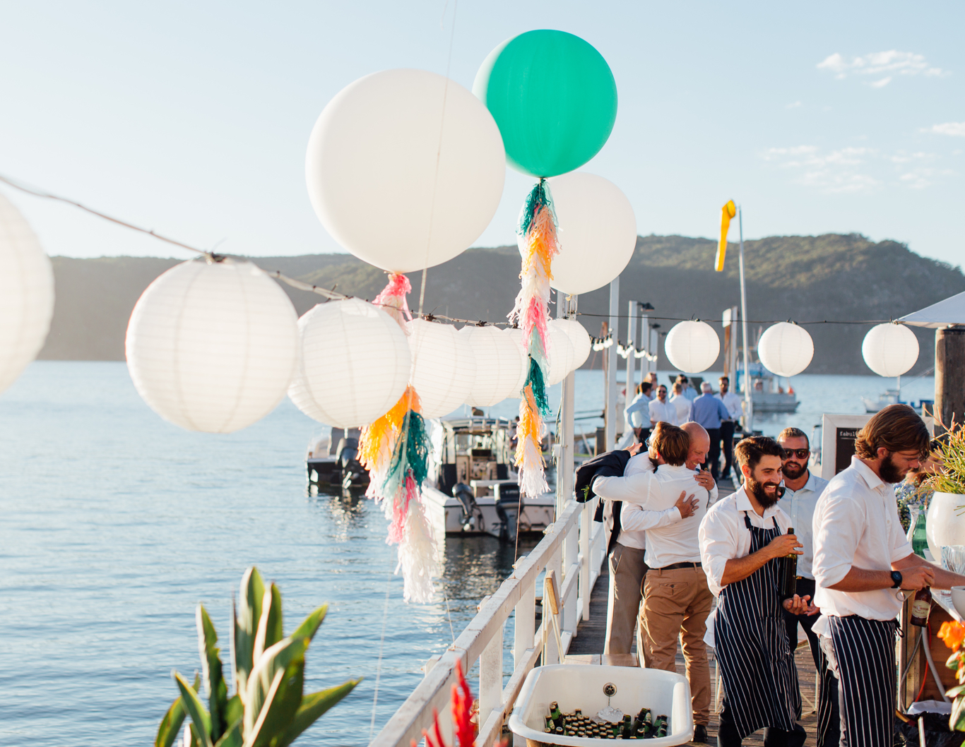 Decorative balloons strung across a jetty.