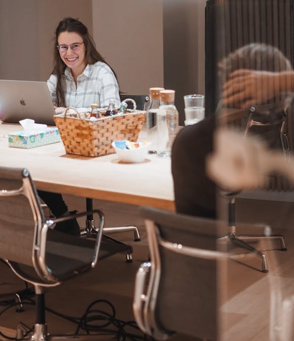 Woman laughing while working at meeting room