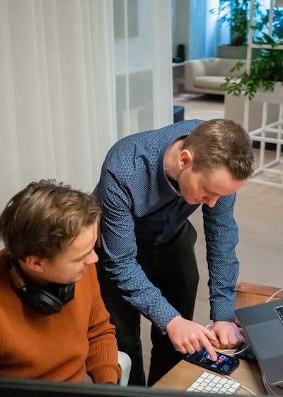 Front end engineer Two men looking to a phone screen developing