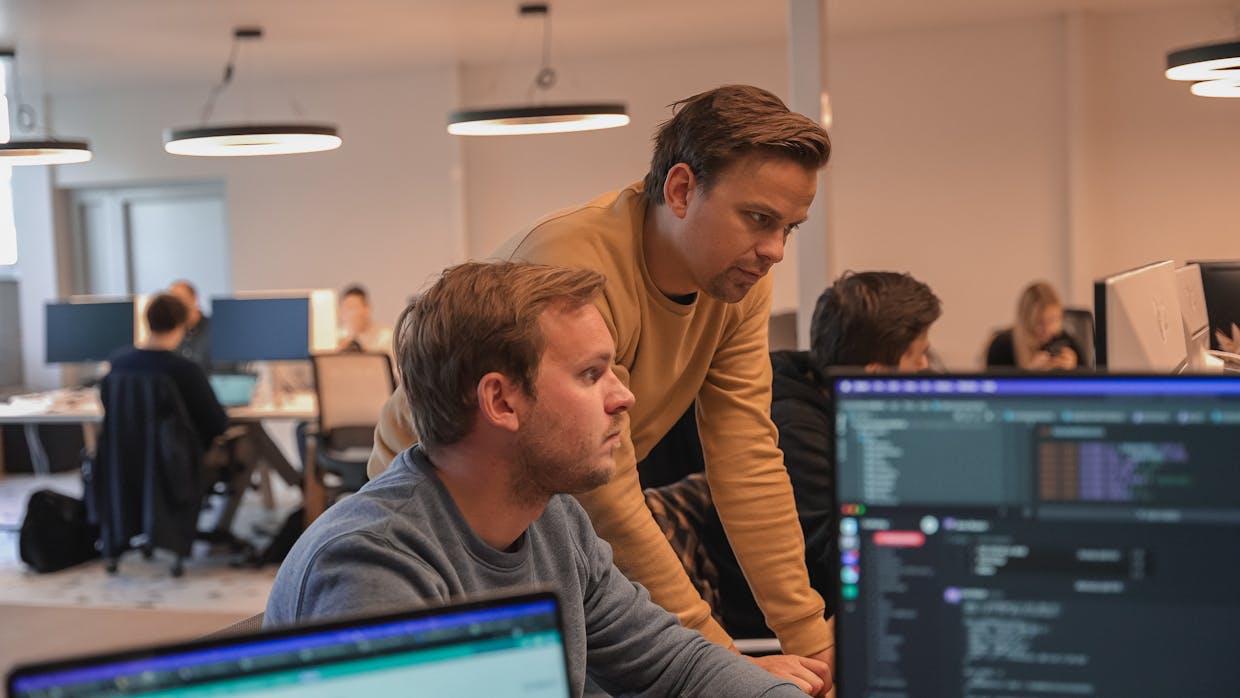 Two men looking at a computer screen in the office