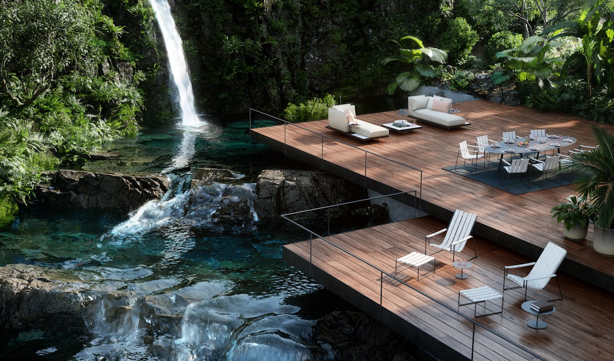 Image of Royal Botania outdoor furniture an a deck next to a beautiful blue waterfall