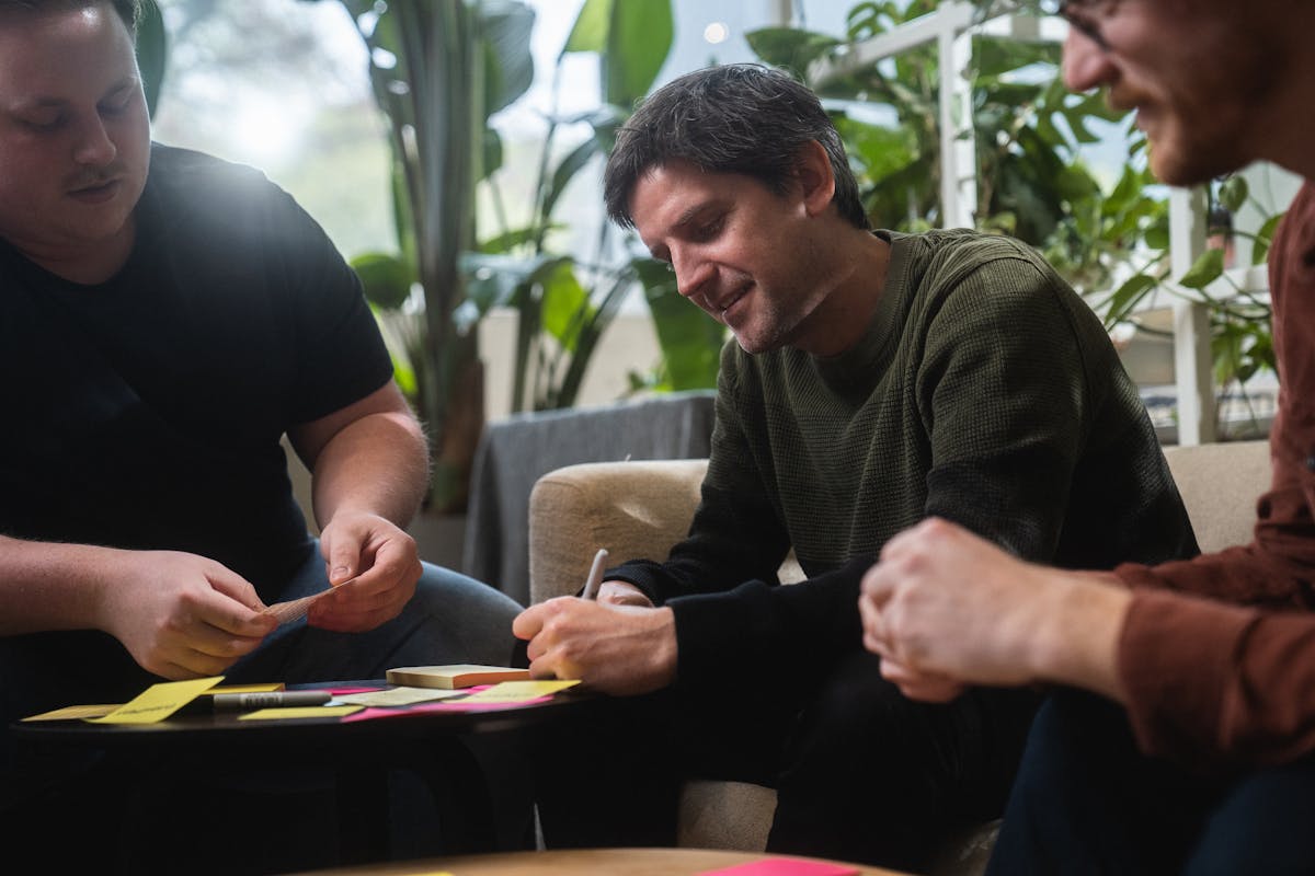 Gijs  brainstorming and writing post-it notes with colleagues Thierry and Stino.