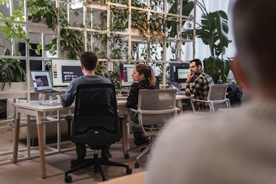 Three colleagues working at their desks at the Craftzing office in Antwerp