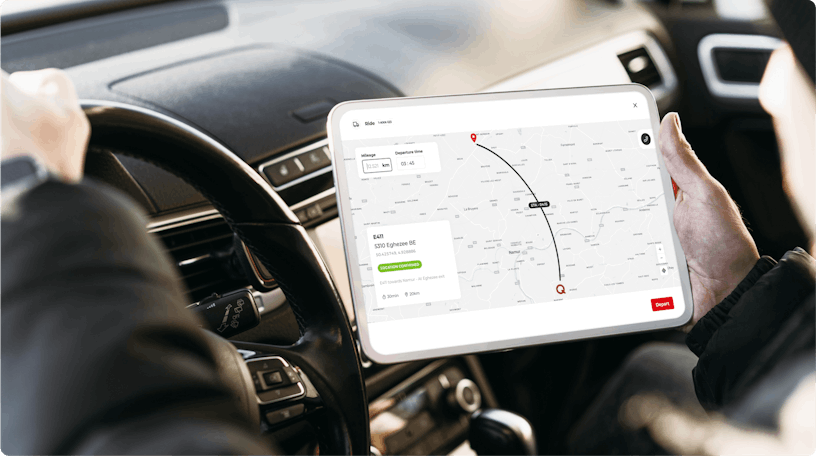 Mock-up of person in a car looking at a screen of the QTeam breakdown app. The screen shows the route the repair specialist needs to travel to get to the location where he a vehicle needs to be repaired.
