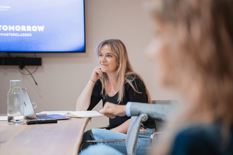Service designer Charlotte Dieltjens sitting at a table