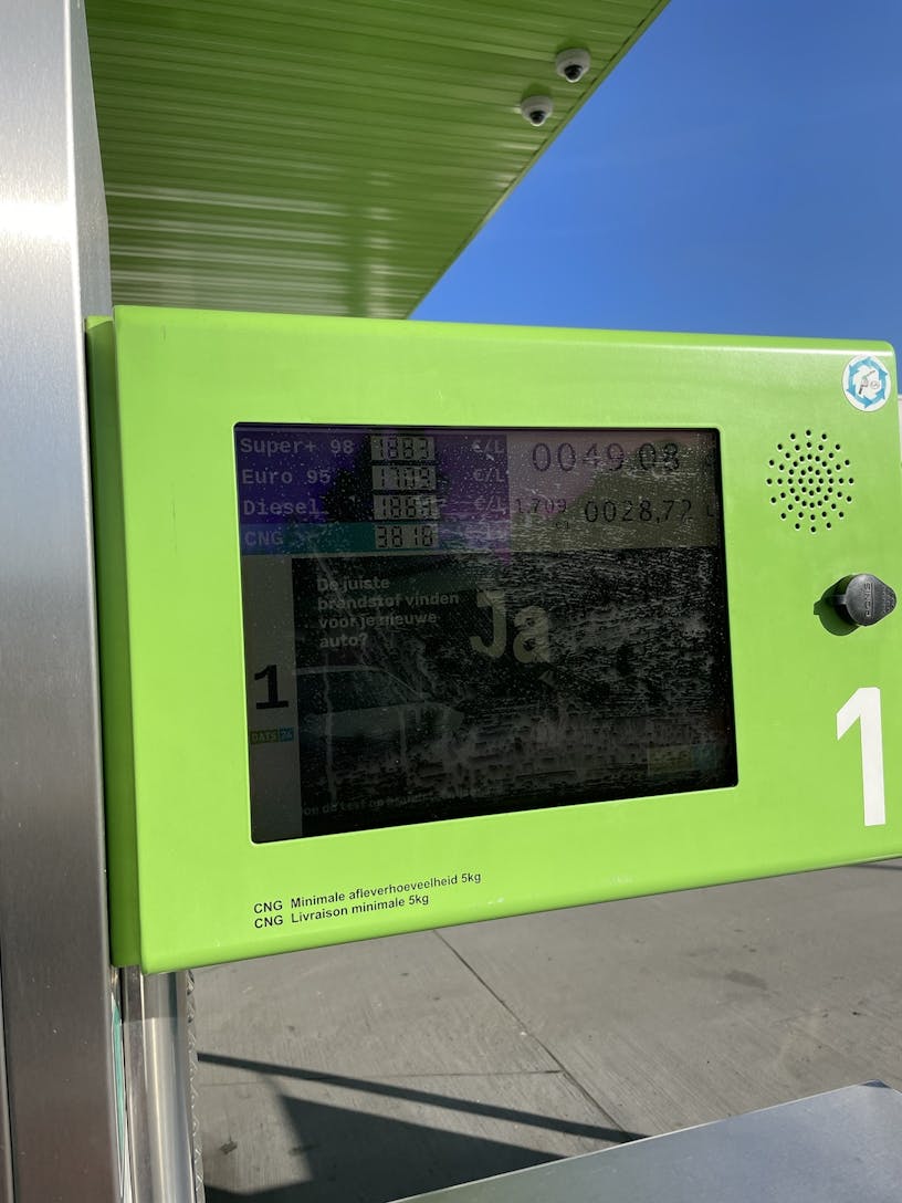 Display of a gas station that became illegible due to sunlight shining on it.