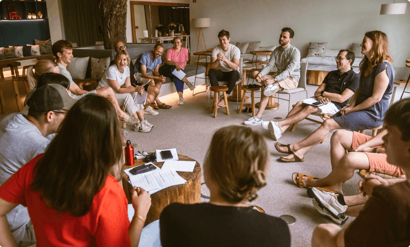 A group of people sitting in a circle discussing something.
