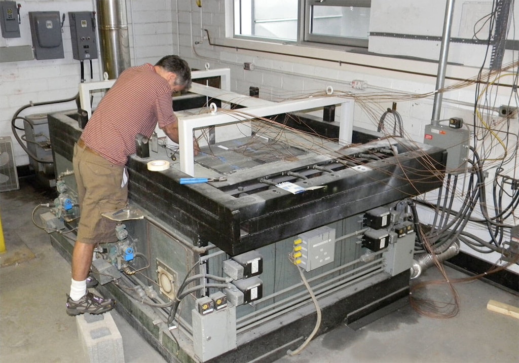 A test sample on top of the furnace is being fitted with Type K thermocouples (notice the yellow connectors on the side of the furnace)