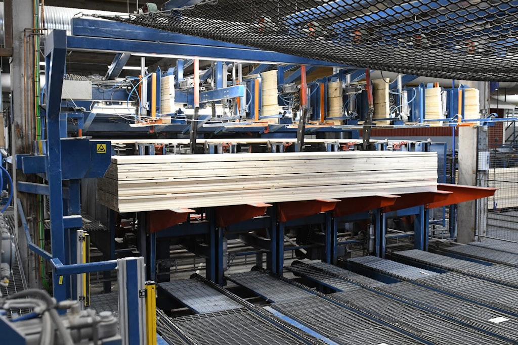 Figure 2. The timber is automatically laid in neat stacks before being moved to the press.