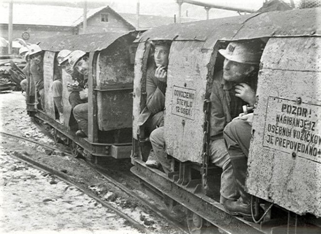 Miners ready to ride a small train into the mine