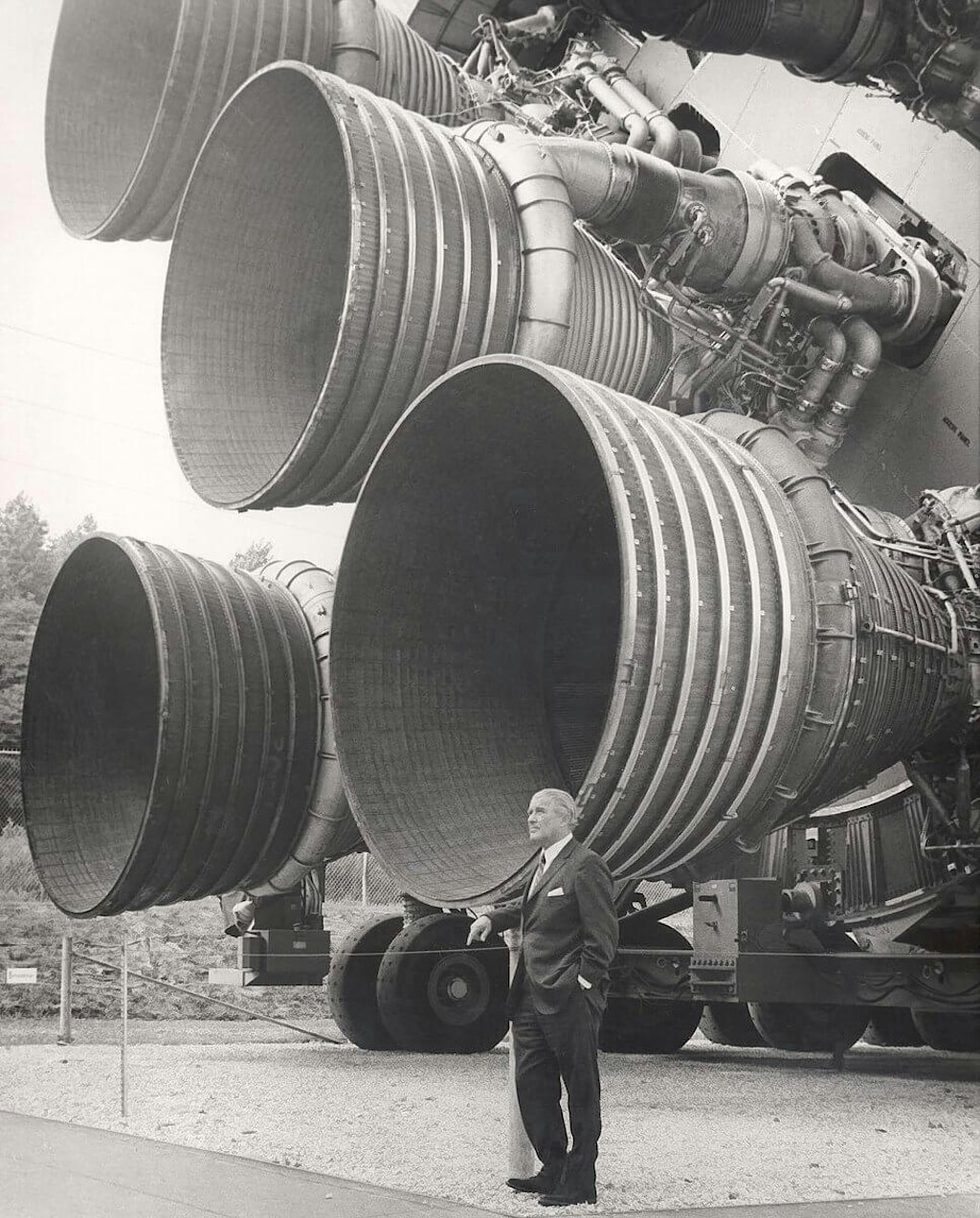 Figura 2. Wernher von Braun in piedi di fronte ai motori F-1 di Rocketdyne del primo stadio di un Saturn V, Huntsville, Alabama.  Foto cortesia della NASA.