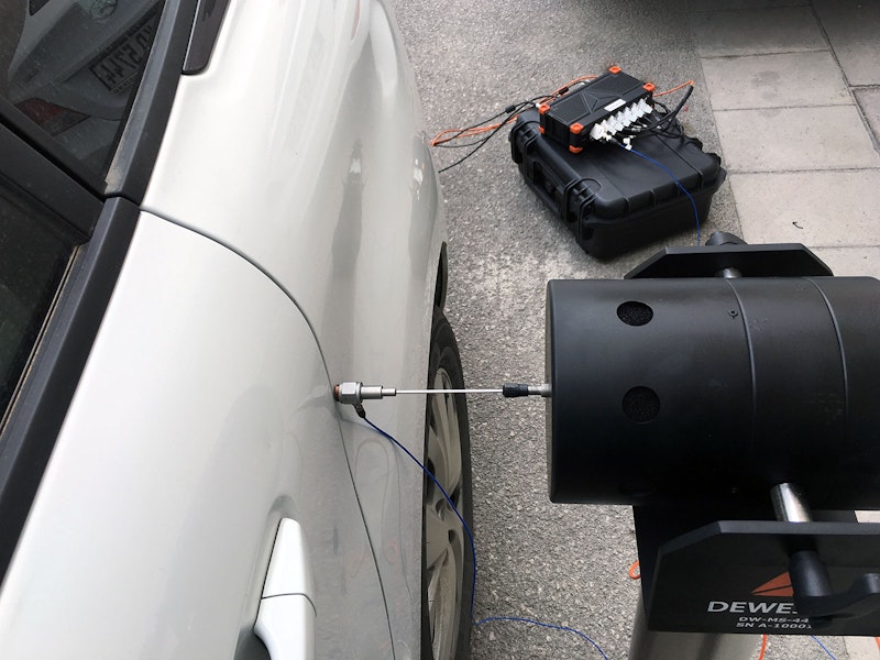 Car body excited with modal vibration shaker and with SIRIUS data acquisition system