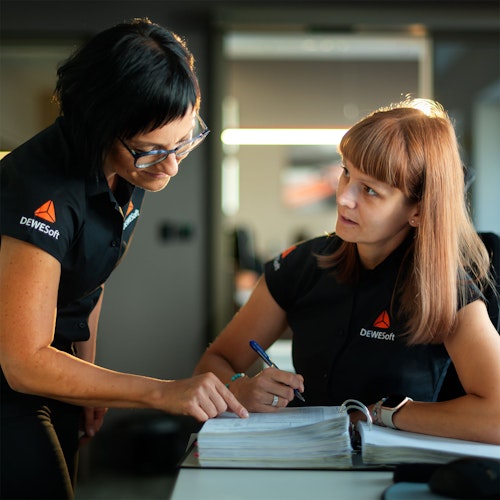 Dewesoft accountants looking at accounting books