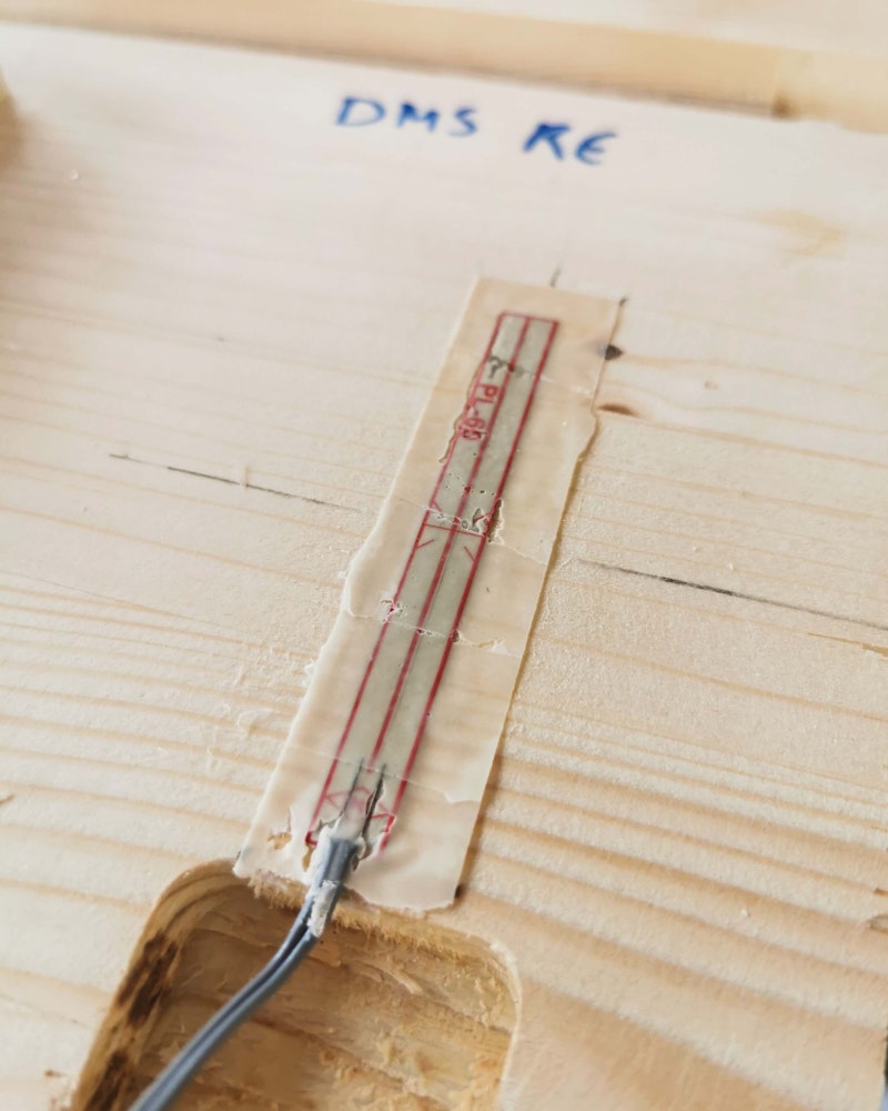 To the left is a strain gauge, and to the right are humidity sensors. Each humidity sensor measures the electrical impedance by two metal screws