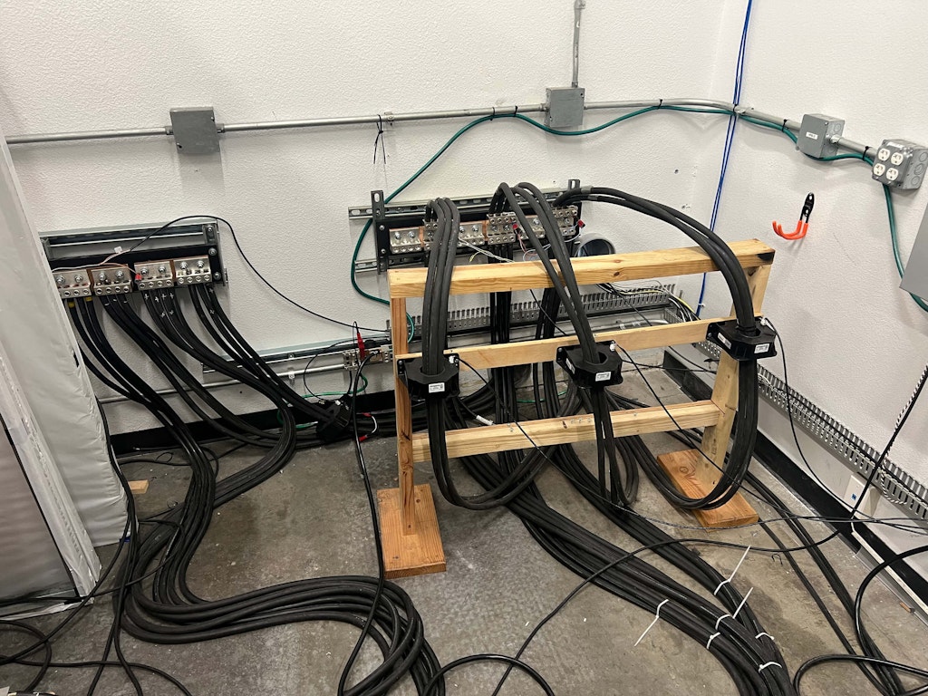 The test bed’s access and product junction point for current and voltage measurement. Notice the three current sensors mounted on the wooden insulator.