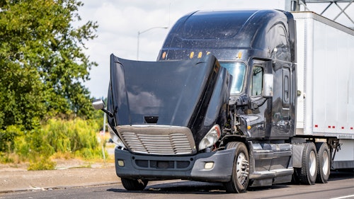 Truck with open hood on a road