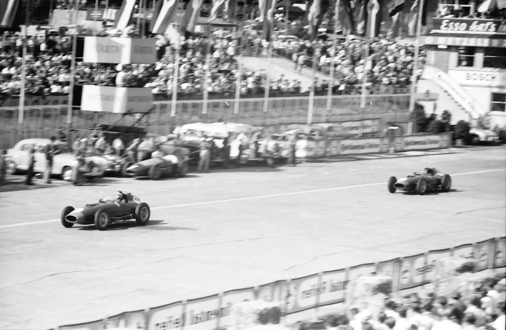 Mike Hawthorn (leading) and Peter Collins' Ferrari 801 cars pass Paco Godia's retired Maserati 250F car late in the 1957 German Grand Prix at Nürburgring. Willy Pragher, CC BY 3.0, via Wikimedia Commons