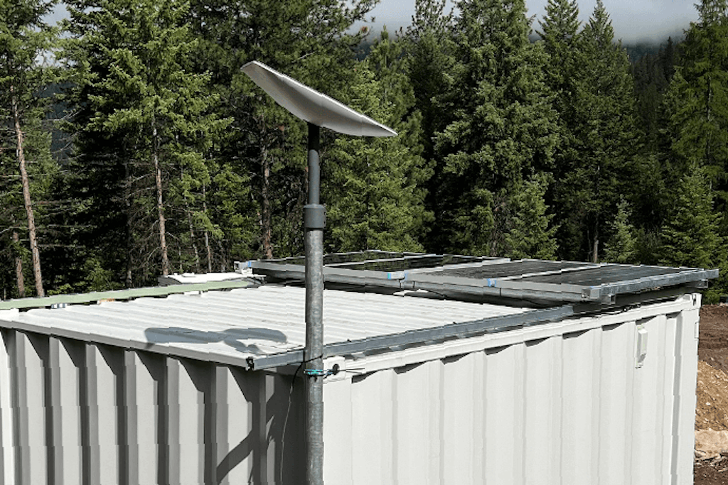 The top of the container with solar panels and Starlink dish