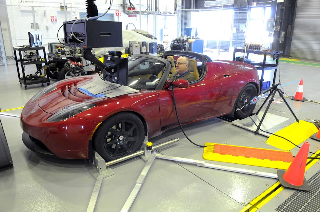 Geoff Amann, senior technician at Argonne’s Advanced Powertrain Research Facility, takes the all-electric Tesla Roadster through a test cycle at the Lab’s two-wheel dynamometer laboratory. The data will help researchers develop test procedures that provide an unbiased, consistent, and practical approach to evaluating electric vehicles. Via Wikimedia Commons