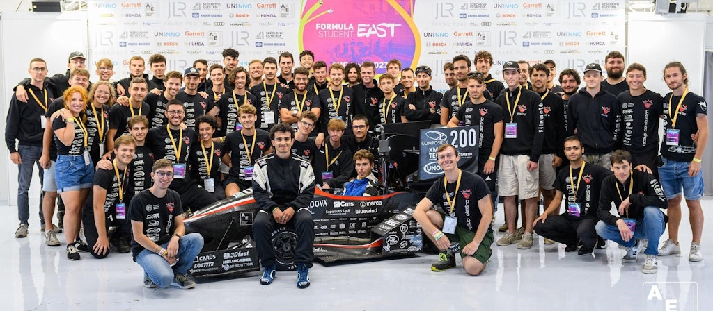 Figure 1. The SGe-06 Electric car and the Race UP Electric Teams at the Hungaroring for the FS East 2023 event.