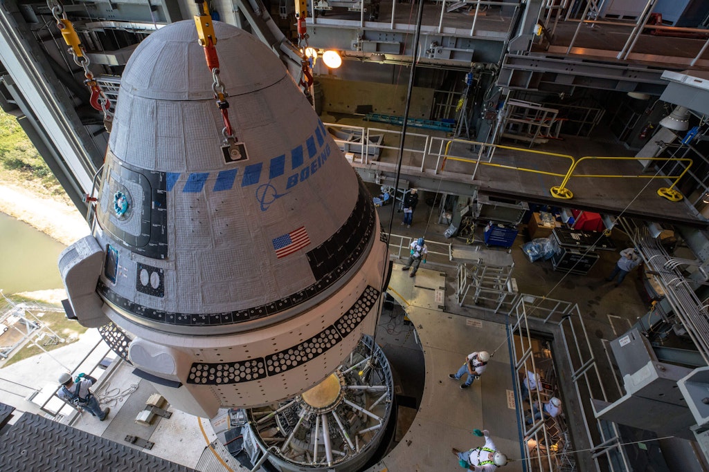 A Boeing CST-100 Starliner spacecraft is guided into position above a United Launch Alliance Atlas V rocket at the Vertical Integration Facility at Space Launch Complex 41 at Florida’s Cape Canaveral Air Force Station. Cory Huston, Public domain, via Wikimedia Commons