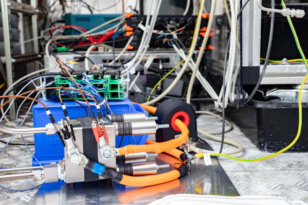 Figure 4. The test engineers used a different (smaller, ca. 75A peak) test electrolyzer stack for demonstration since the customer project is under NDA. The SIRIUS is visible in the background on top of the Regatron power supply, next to the function generator.
