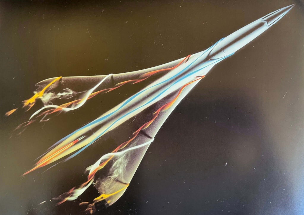 Vortices form at the upper surfaces of the delta wings in this wind tunnel test image. Photo: Frederic Beniada and Michel Fraile