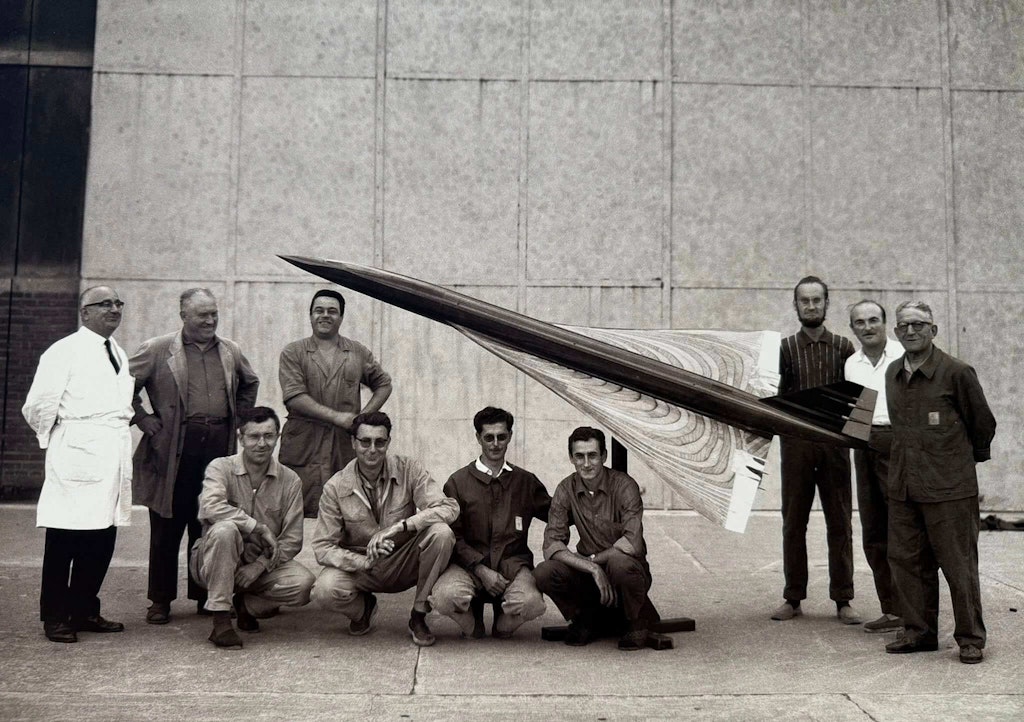 Engineers pose with a wooden model of Concorde. Photo by Frederic Beniada and Michel Fraile.