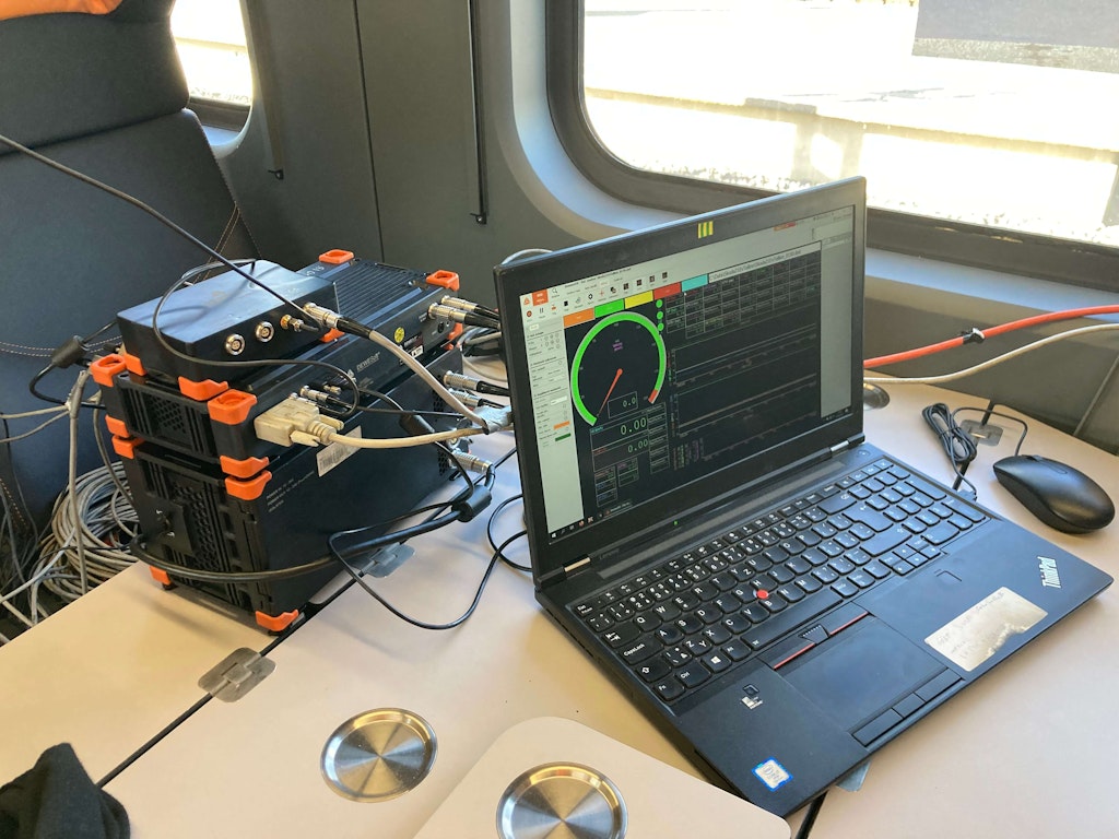 Figure 2. The measurement setup in the wagon with SIRIUS devices and a laptop running DewesoftX.