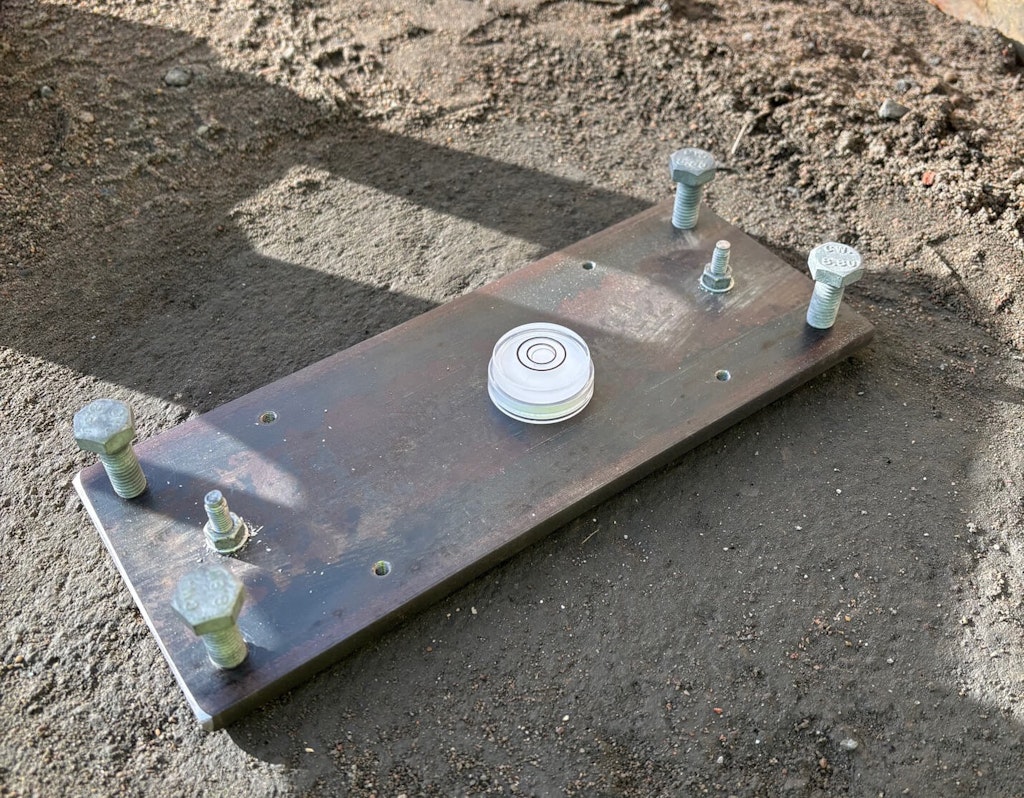 Figure 6. Mounting plate fully installed. Two M6 Expansion bolts screws to hold the plate down and four M10 Bolts as balancing bolts to level out the plate.