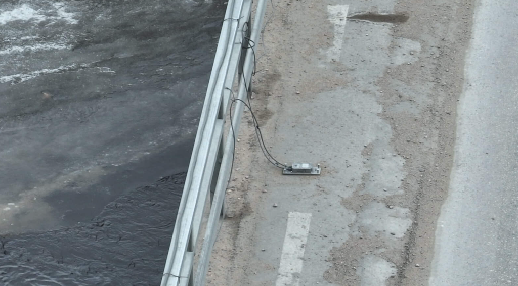  Figure 9. A close-up view of an accelerometer mounted on its plate, ready to capture the bridge's subtle movements.