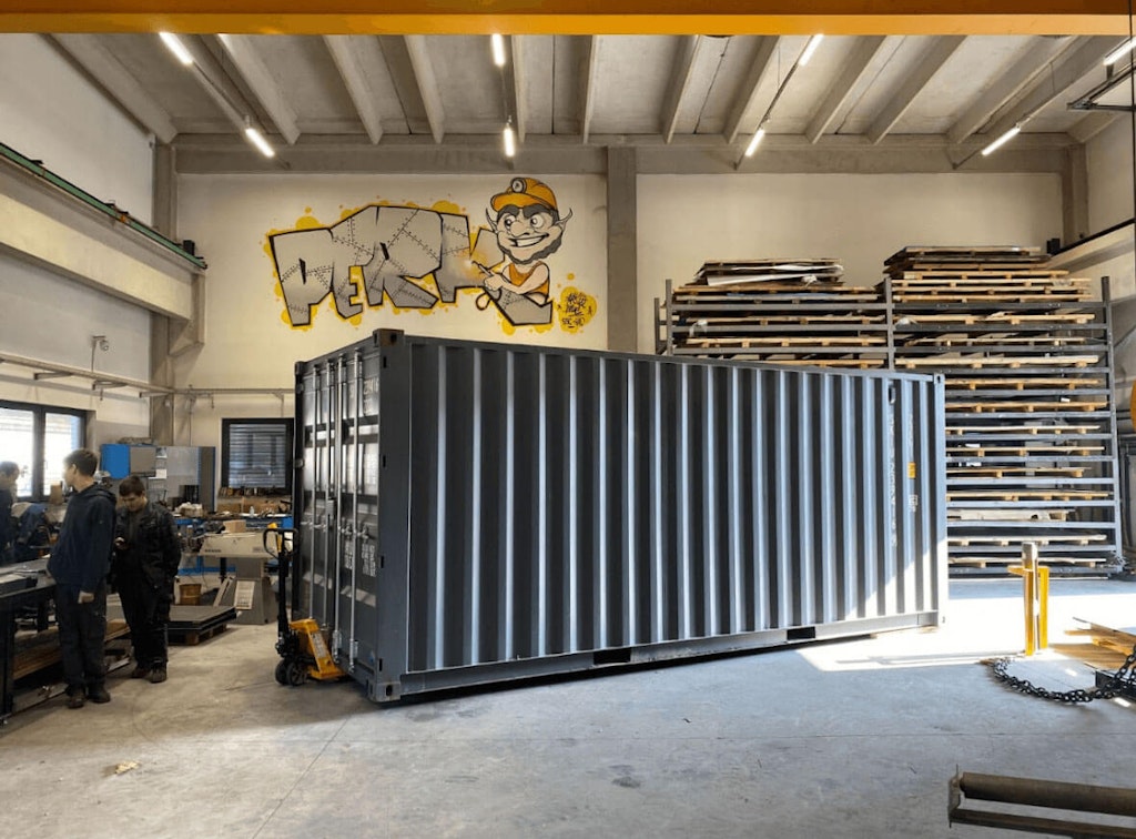 One of two unfinished shipping containers waiting to be cut and welded